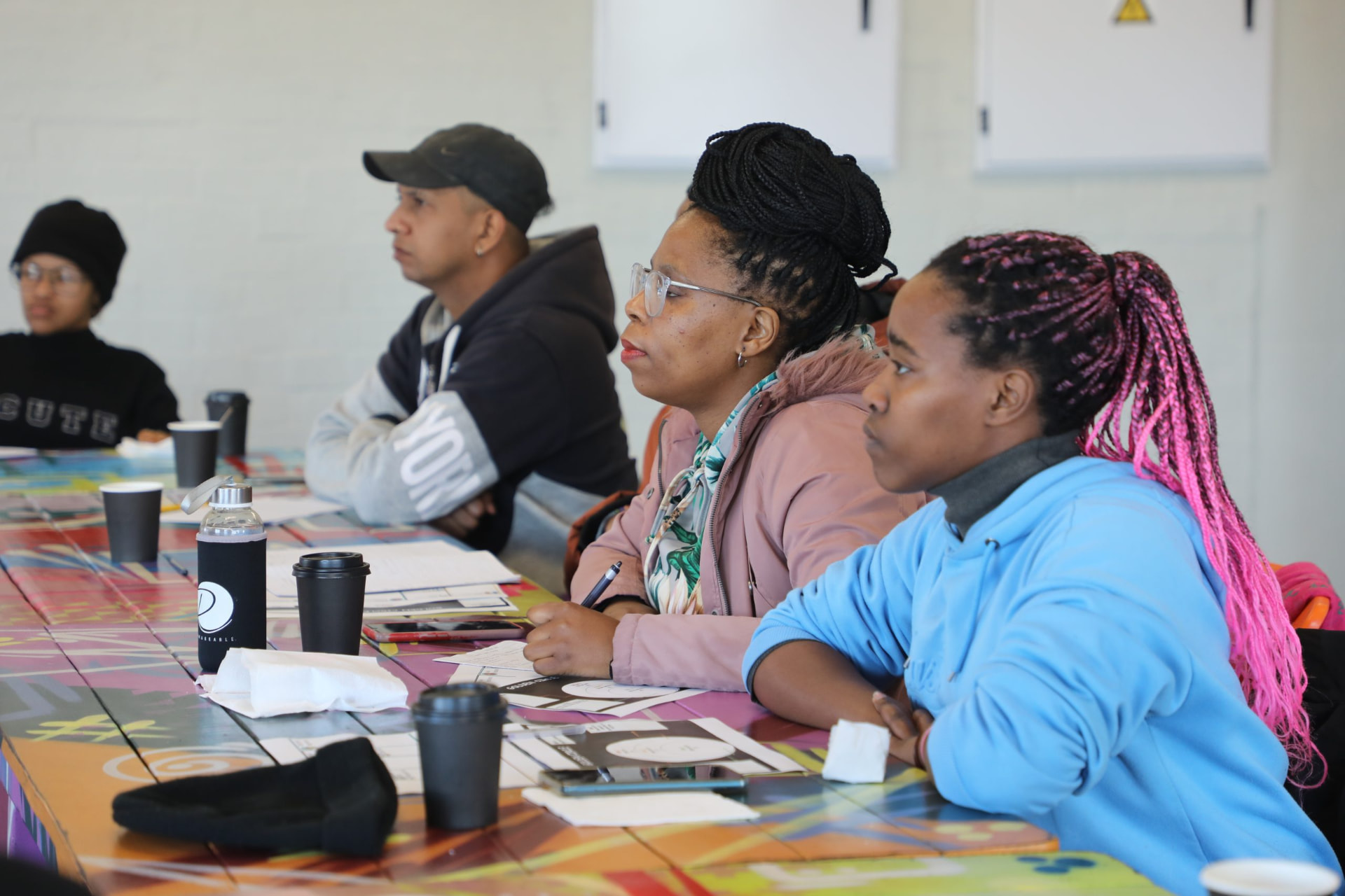Learners seated around a table during an academy workshop