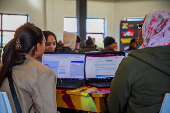 Participants seated at computers in a learning space